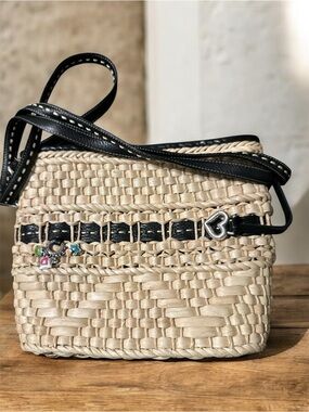 Brighton woven straw and leather trim crossbody bucket bag.